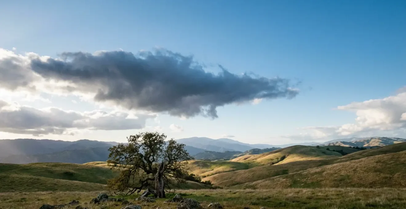 Wide landscape showing brief storm cloud passing over serene countryside